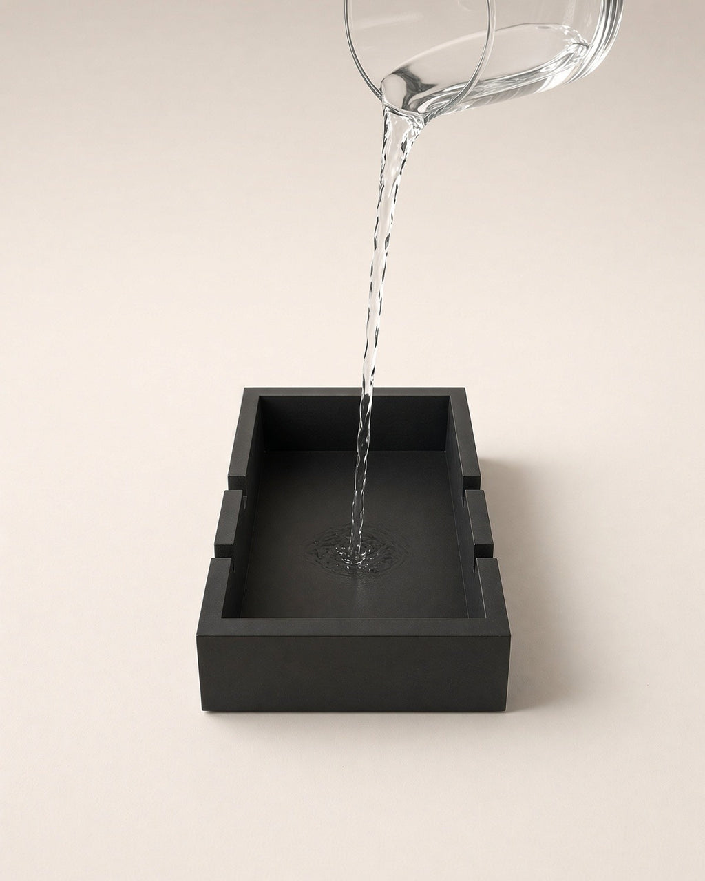 Water poured from a glass jug into the stand's water well